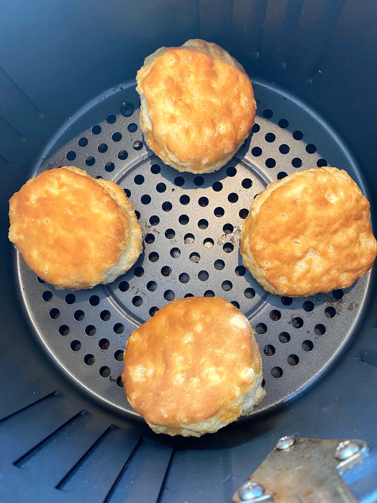 Cooked biscuits in an air fryer.