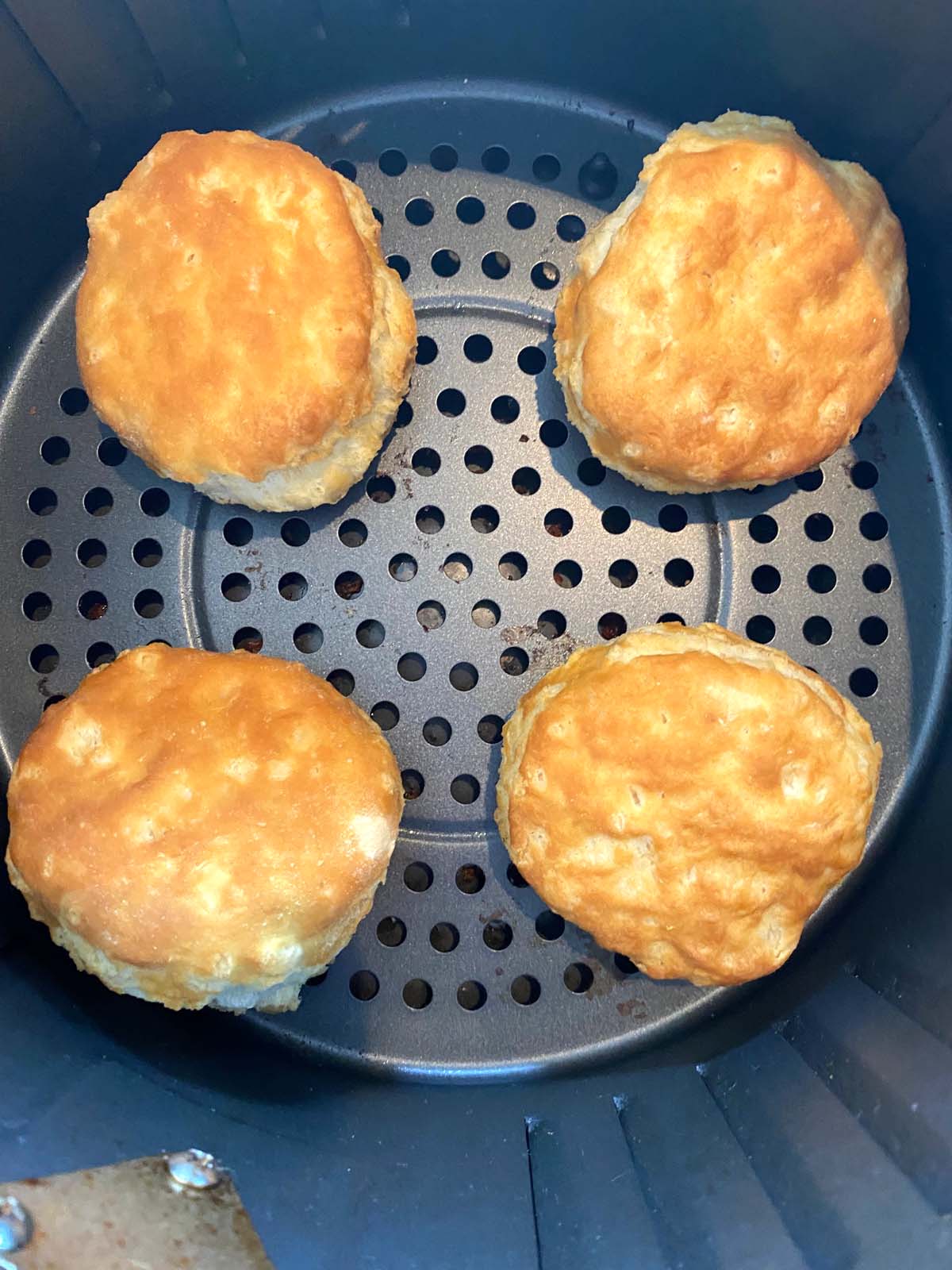 Cooked biscuits in an air fryer.