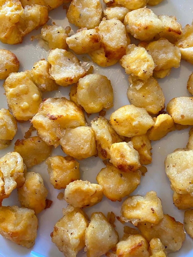 golden brown cooked cheese curds on a plate