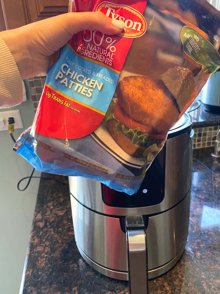 package of frozen breaded chicken patties in front of air fryer