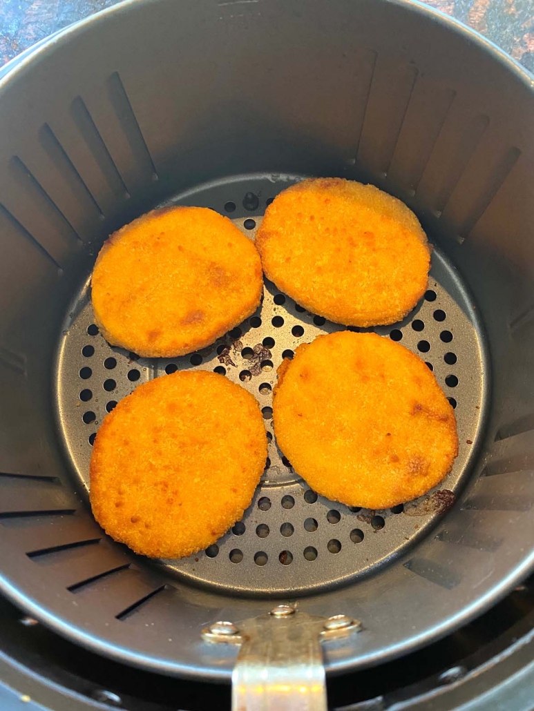 breaded chicken patties in bottom of air fryer basket