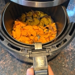 Cooked sweet potato chips in an air fryer.