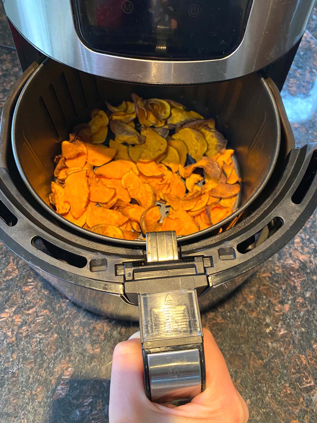 Cooked sweet potato chips in an air fryer.