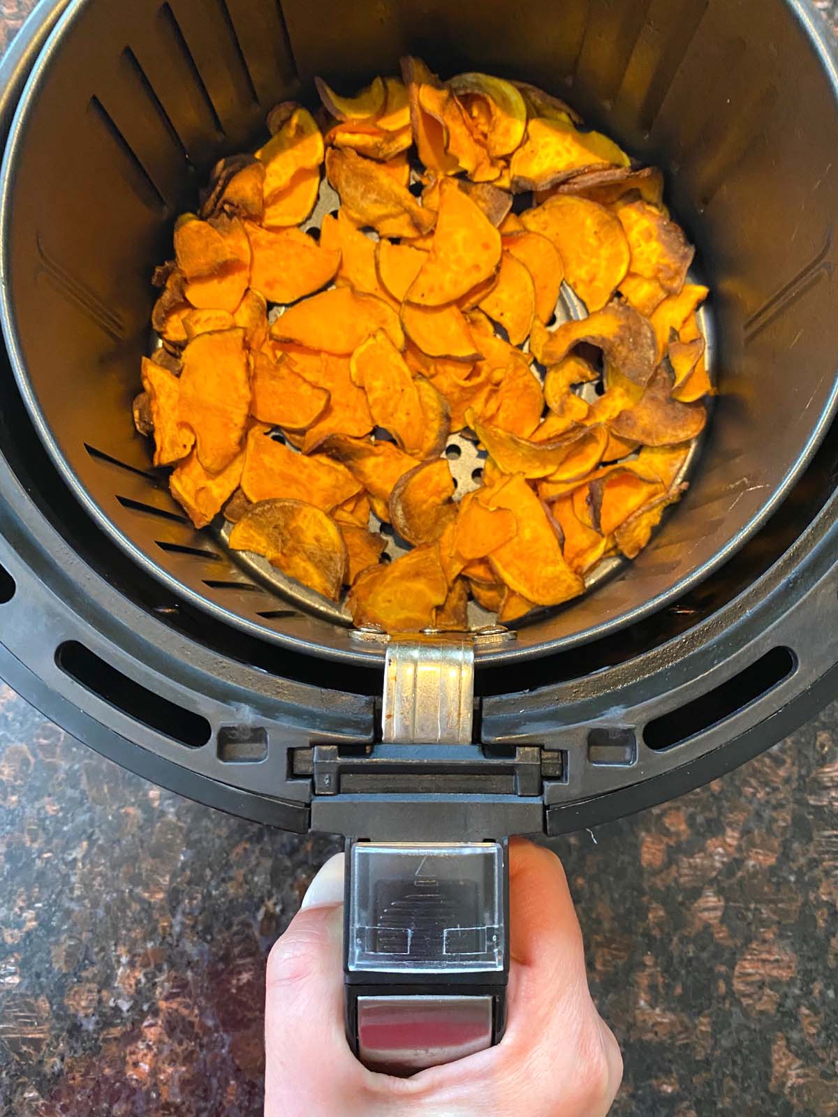 Cooked sweet potato chips in an air fryer.