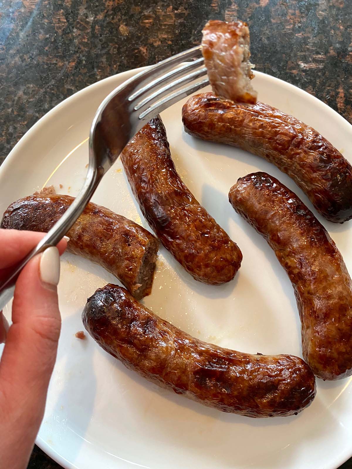 Cooked bratwurst on a plate.