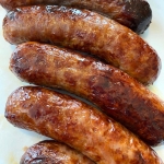 Cooked bratwurst on a plate.