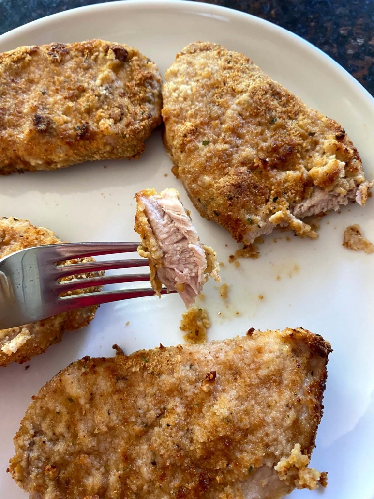 fork with a piece of breaded pork chops