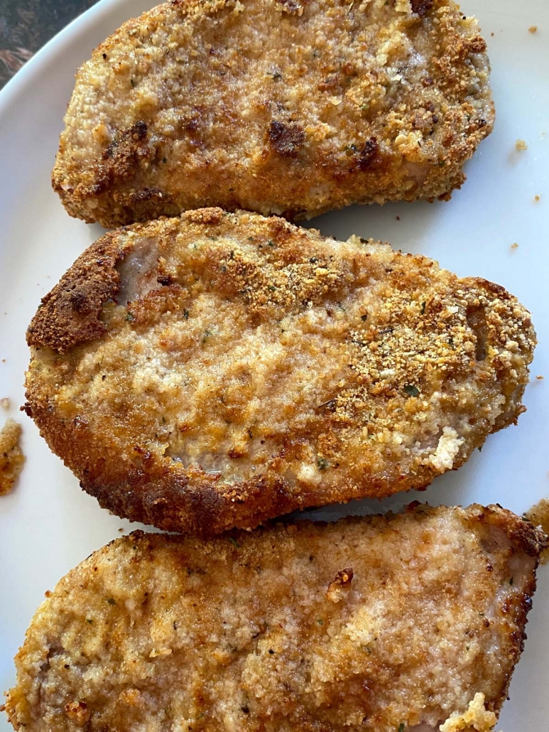 breaded pork chops on a plate