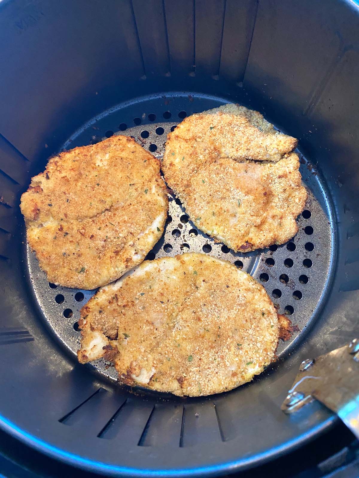 3 air fried turkey cutlets in basket.