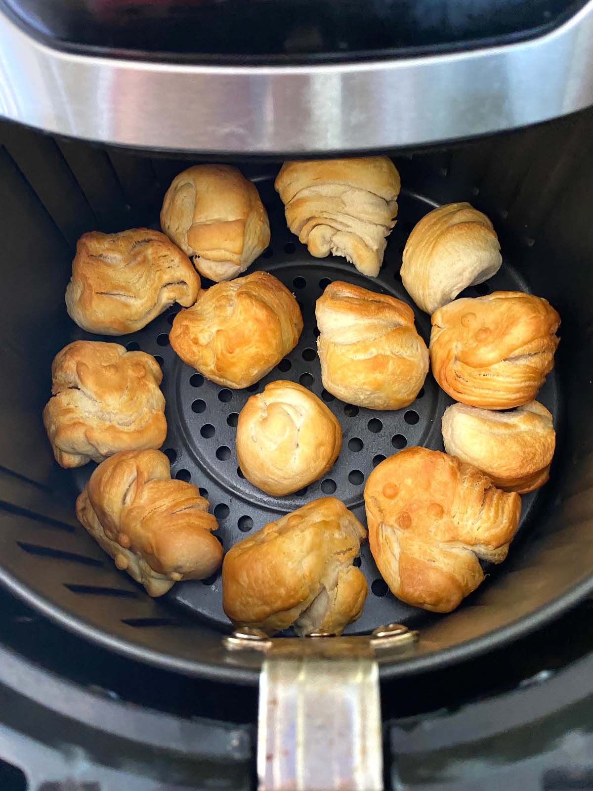 Cooked donut holes in an air fryer.