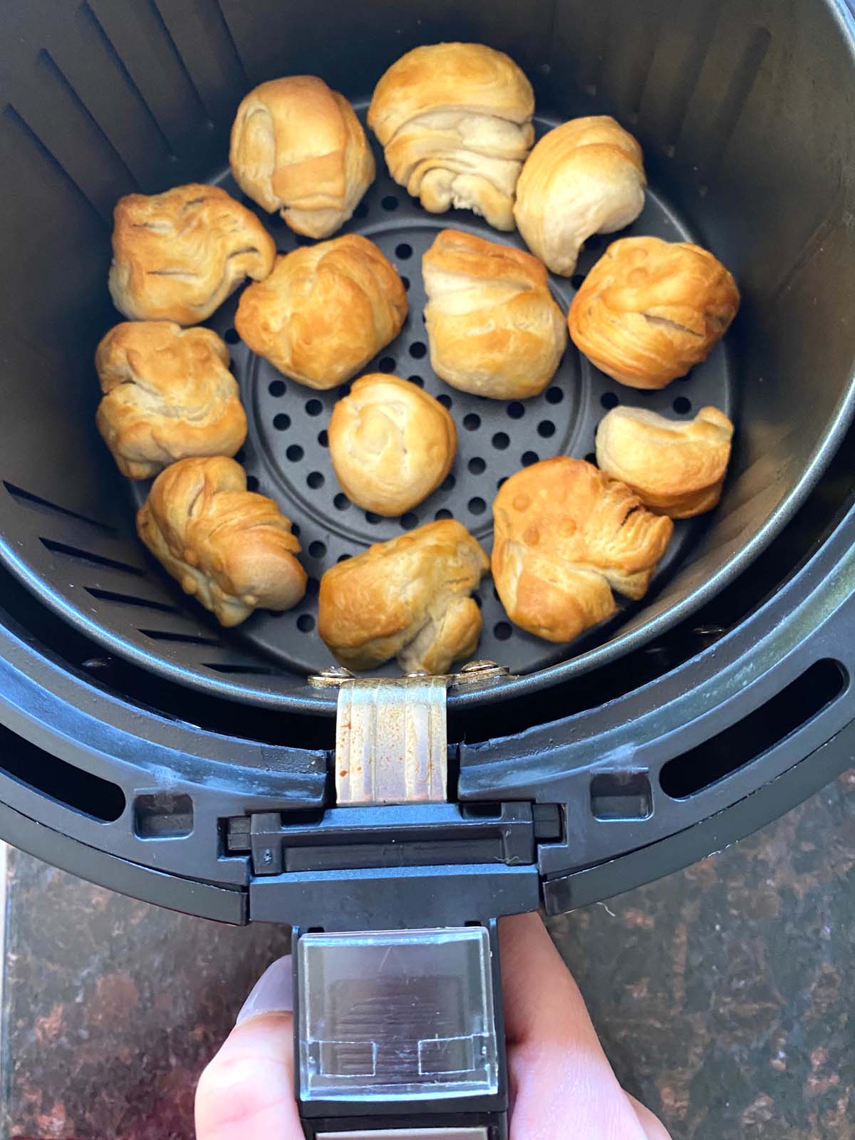 Cooked donut holes in an air fryer.