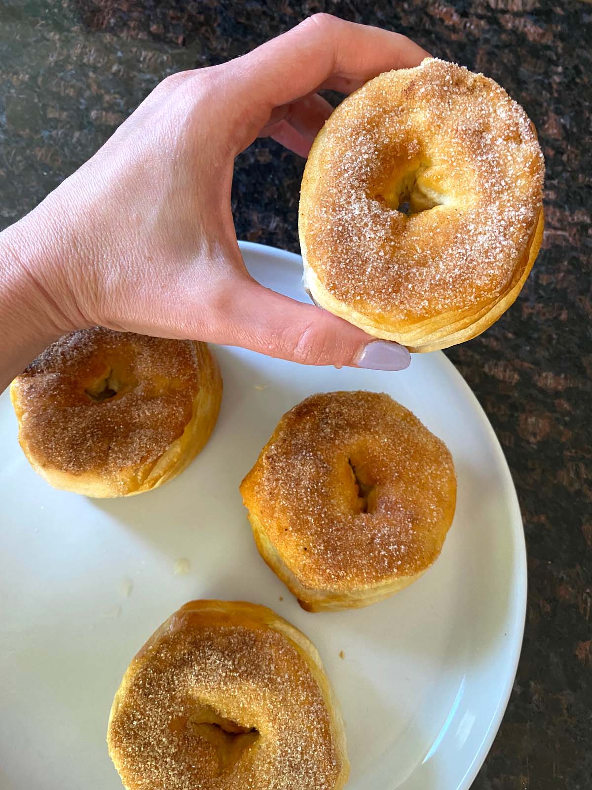 Cinnamon sugar biscuit donuts on a plate. 
