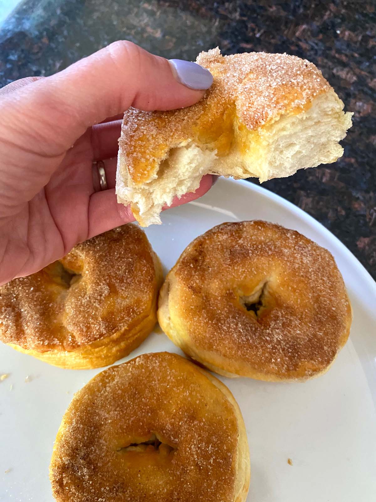 Cinnamon sugar biscuit donuts on a plate. 