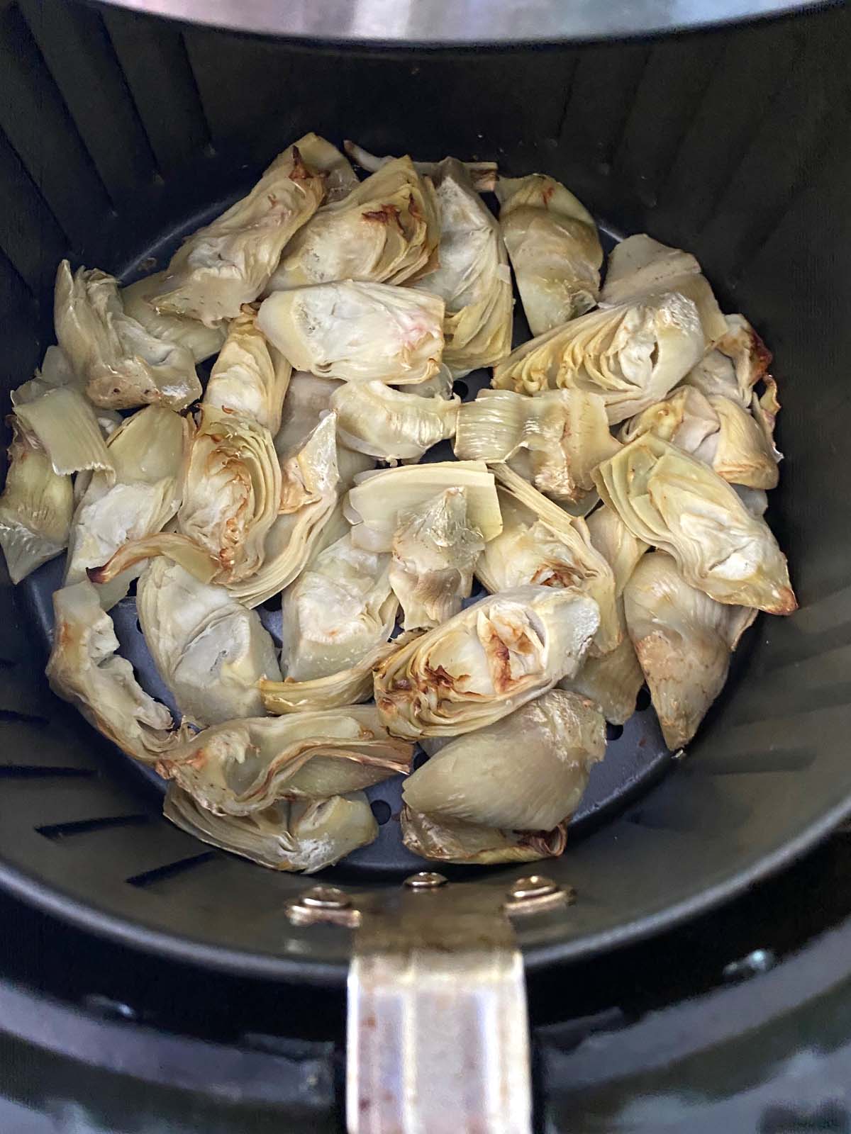 Cooked artichoke hearts in an air fryer.