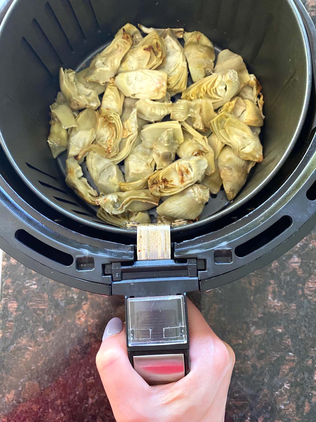 Cooked artichoke hearts in an air fryer.