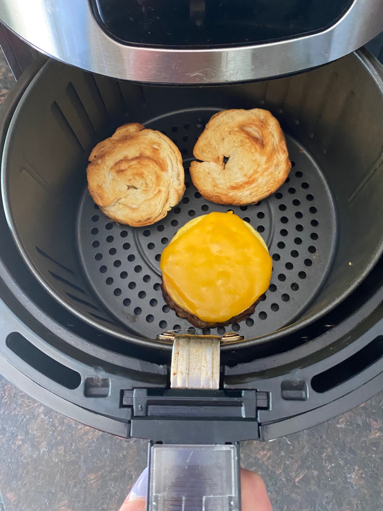Breakfast croissant in an air fryer.