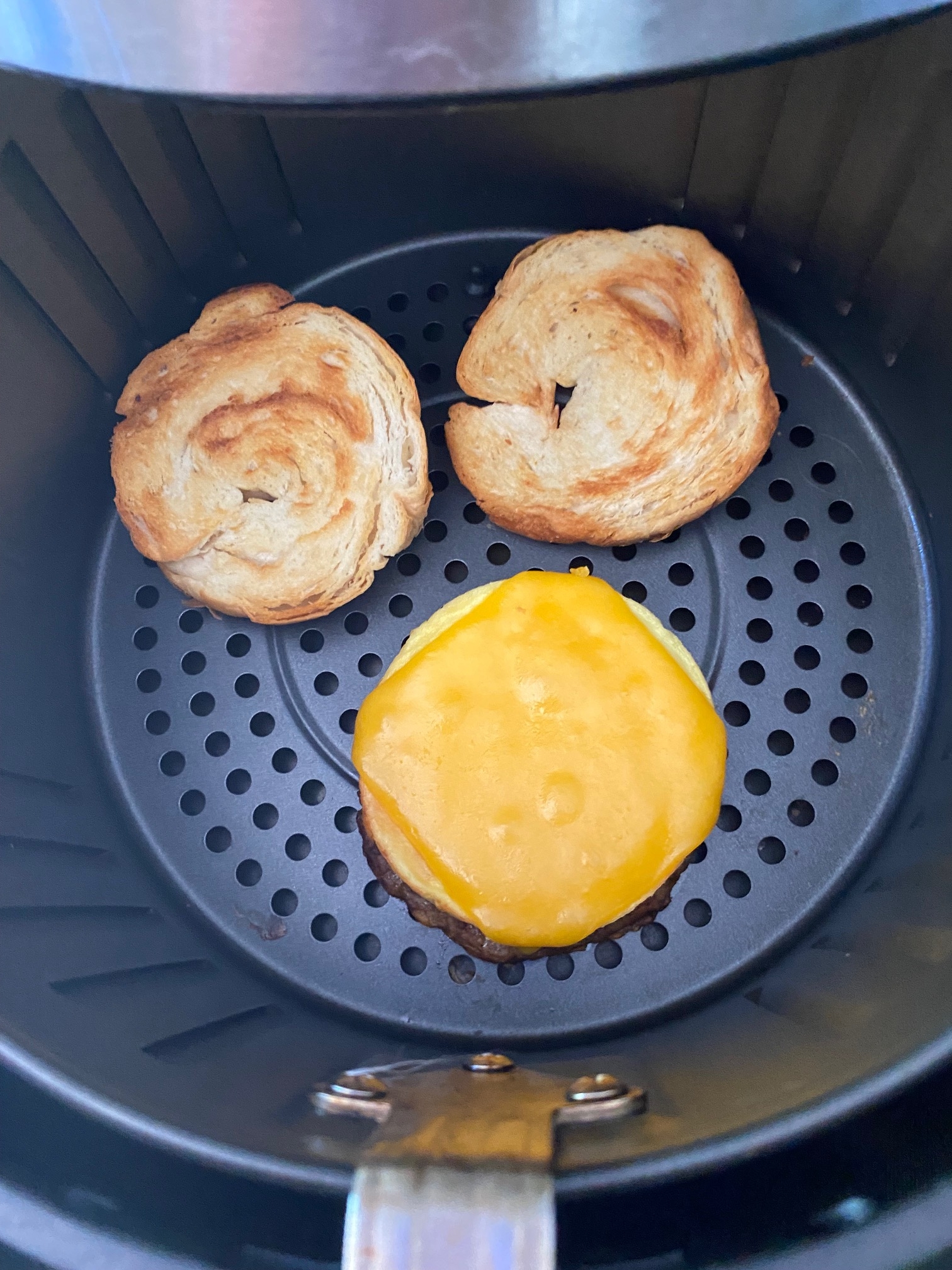 Breakfast croissant in an air fryer.
