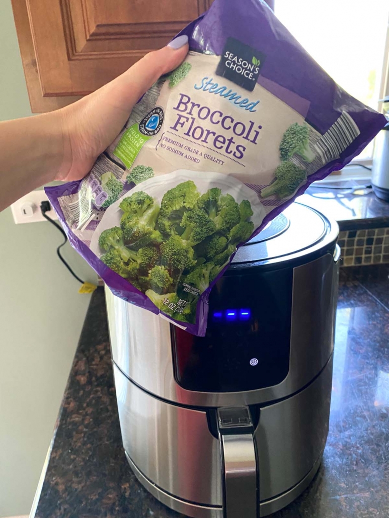 package of frozen broccoli in front of air fryer