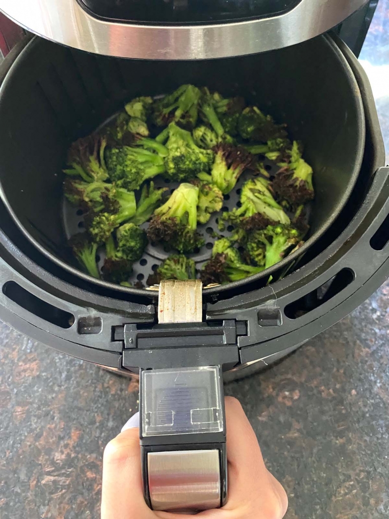 air fryer opened to show cooked broccoli