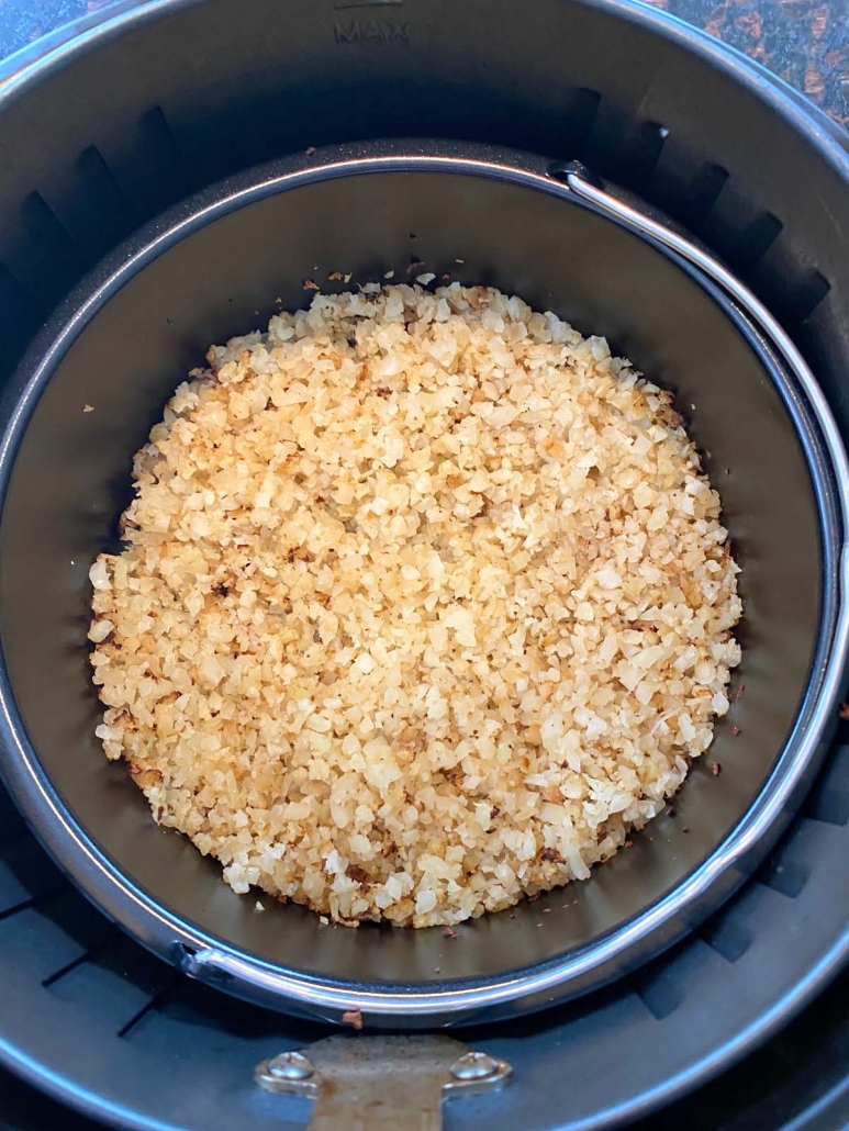 close-up of cauliflower rice in air fryer pan