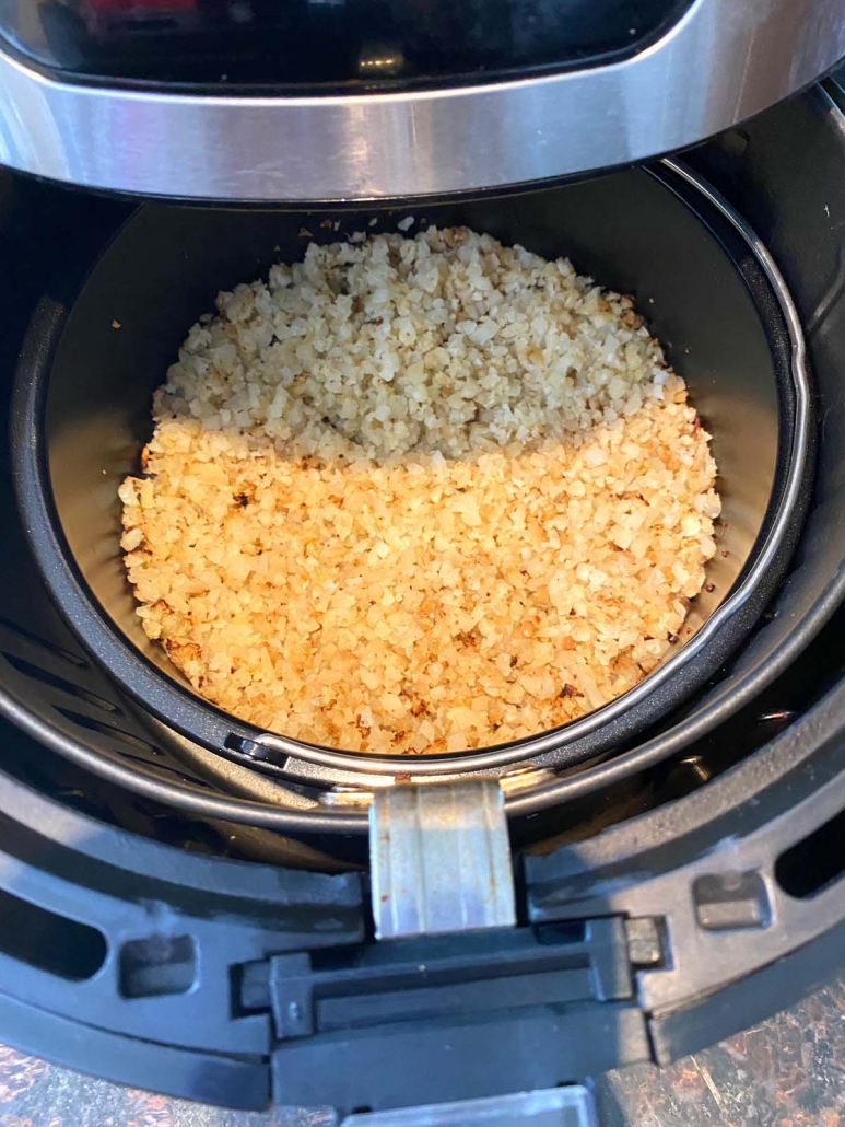 air fryer opened to show cauliflower rice inside