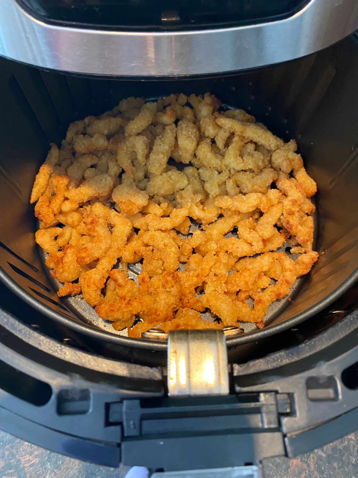 Cooked clam strips in basket.