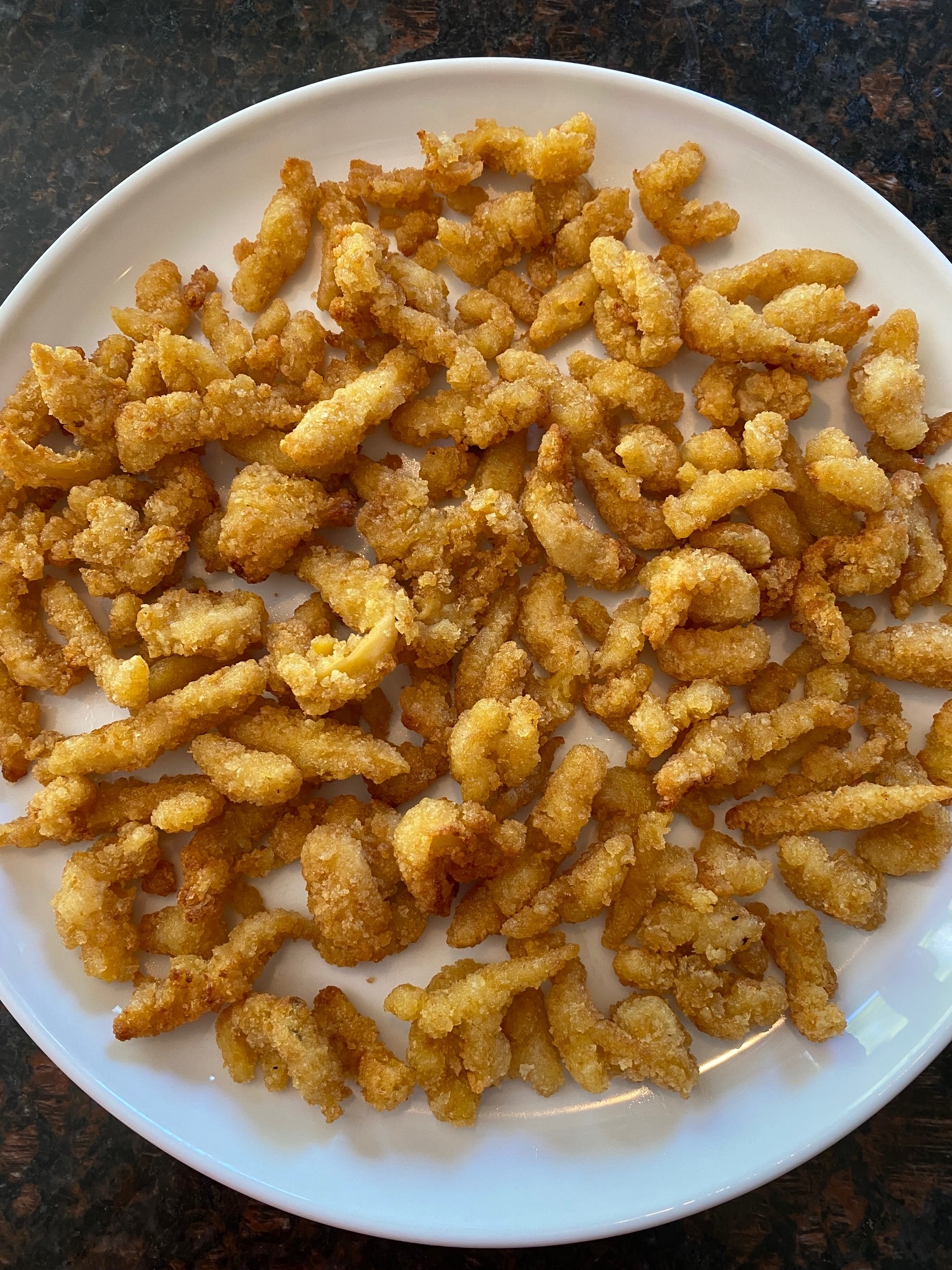 Plate of crispy air fried clam strips.
