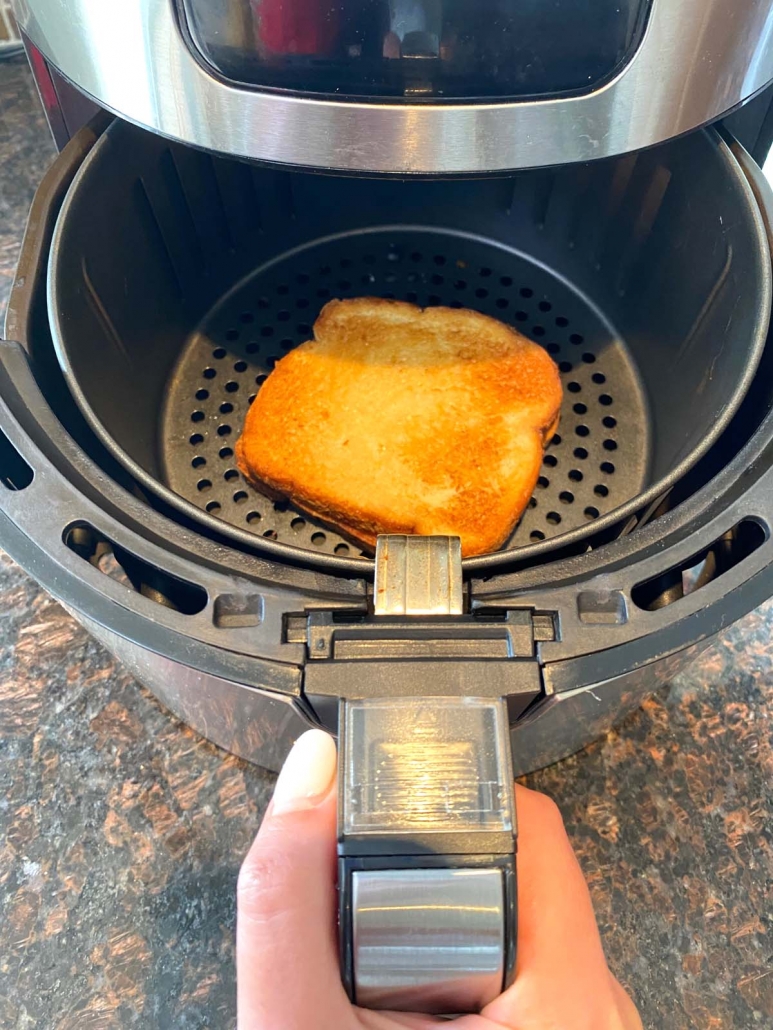 air fryer opened to show toasted sandwich
