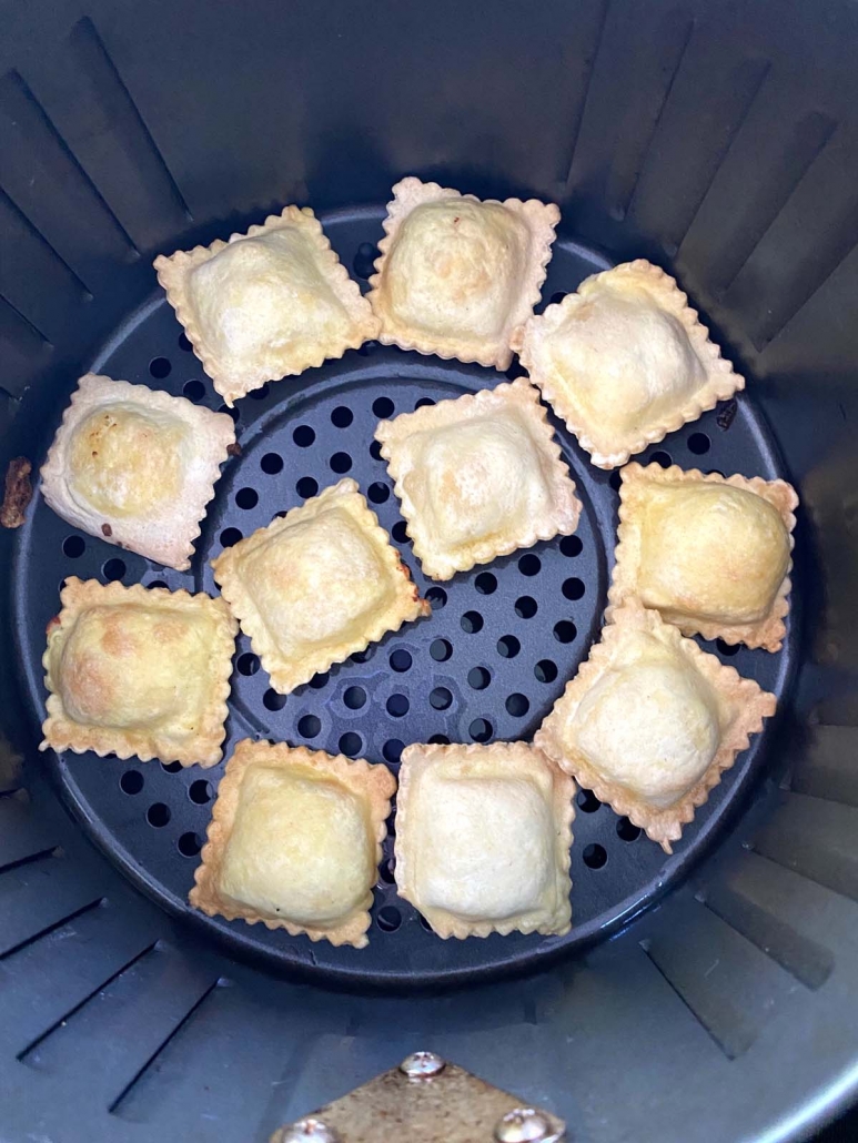 ravioli in a single layer in air fryer basket