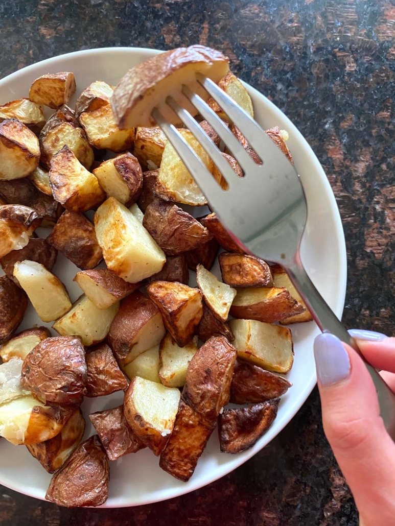 fork with piece of cooked red skin potato