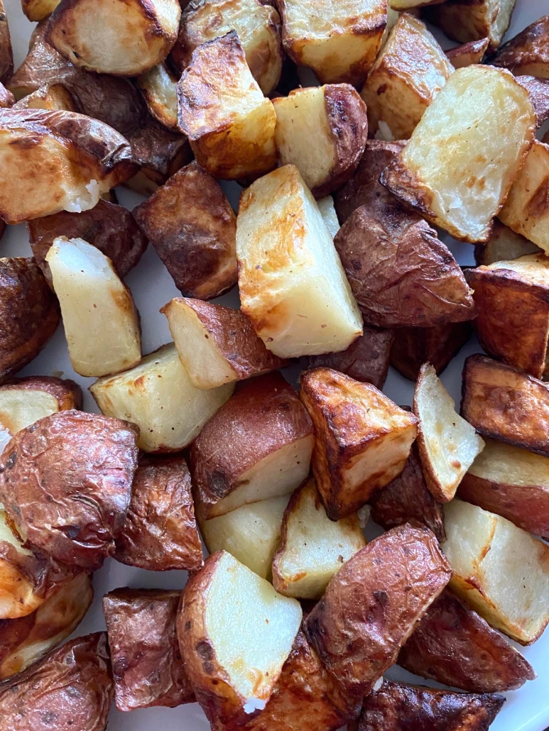 cooked and seasoned red skin potatoes on plate