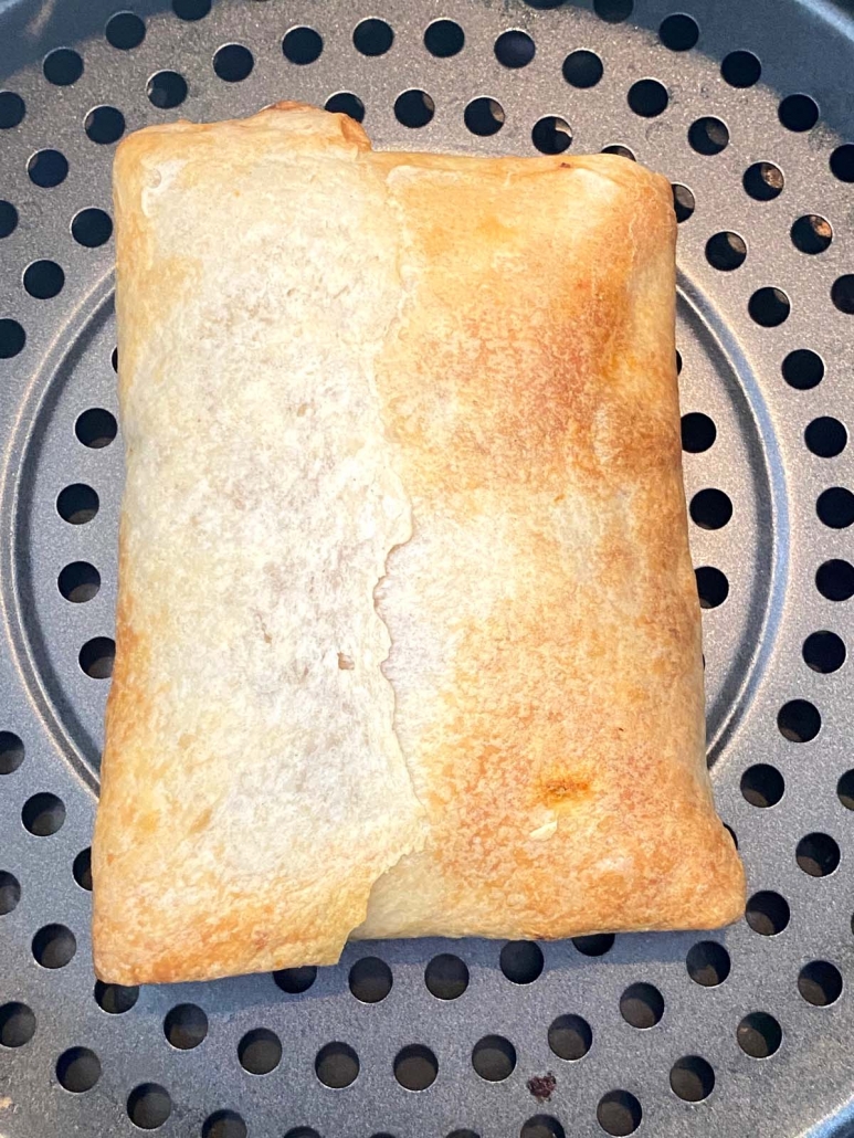 close up of air fried pizza puff inside air fryer