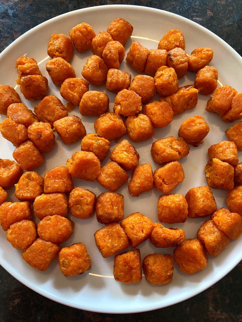 a plate filled with air fried sweet potato puffs
