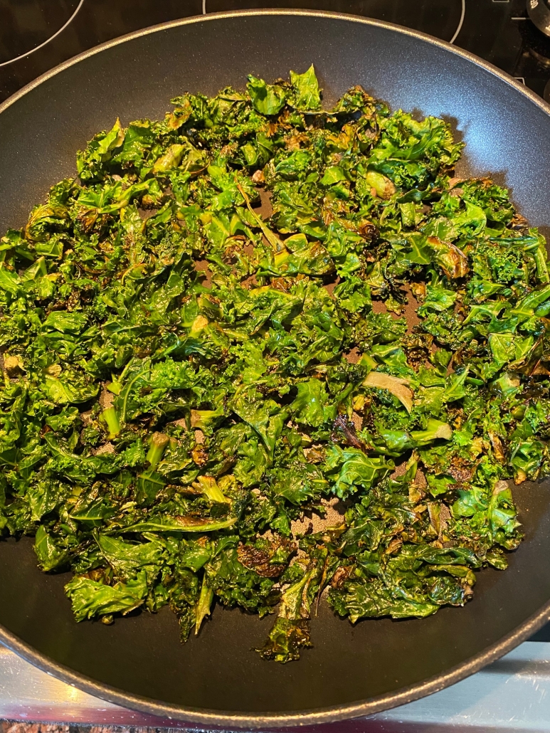 fresh kale sauteed in frying pan