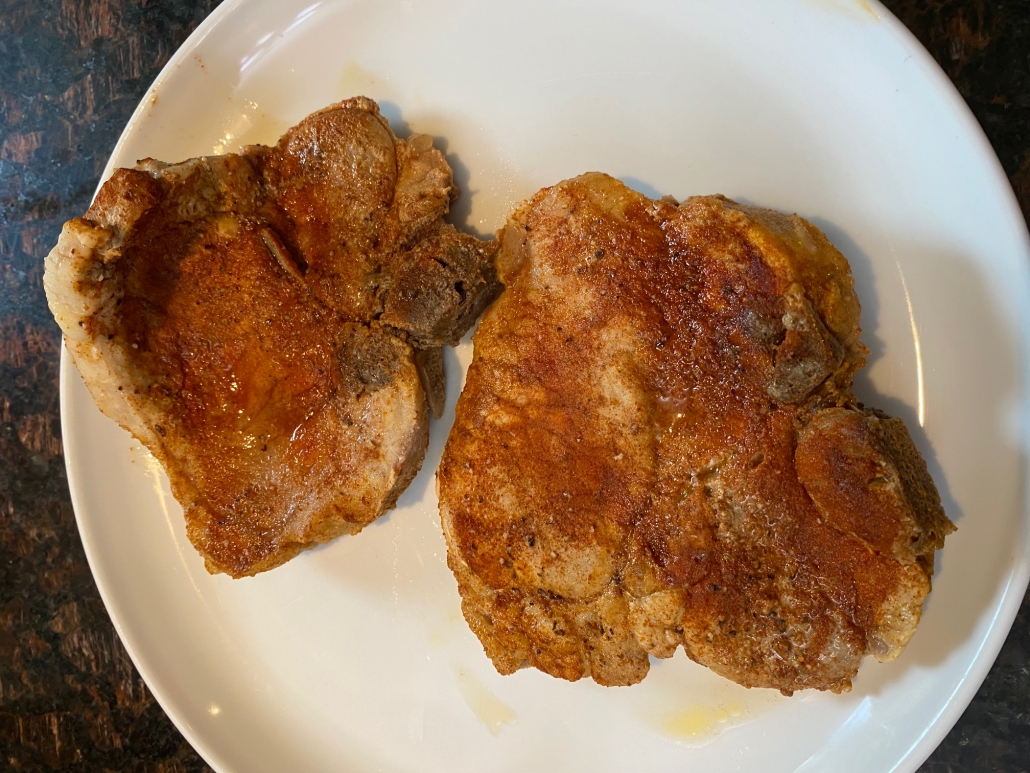 seasoned bone in pork chops on a plate