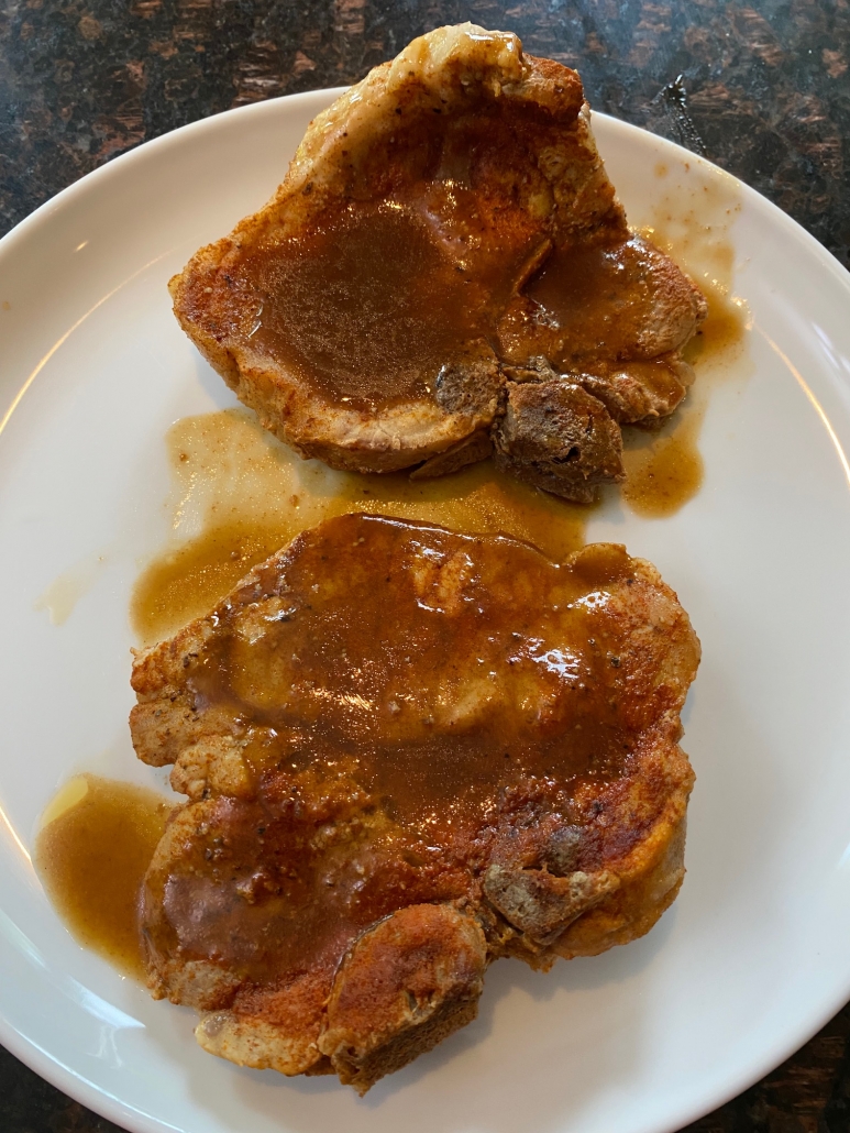 cooked bone in pork chops on a plate