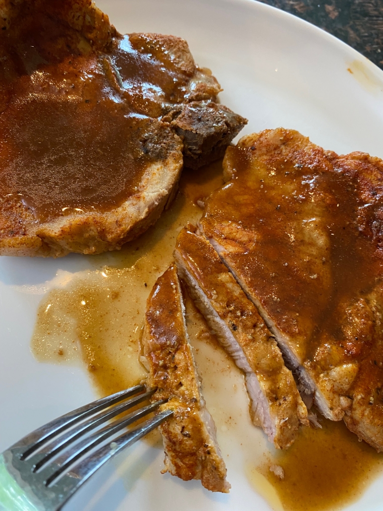 cooked bone in pork chops on a plate