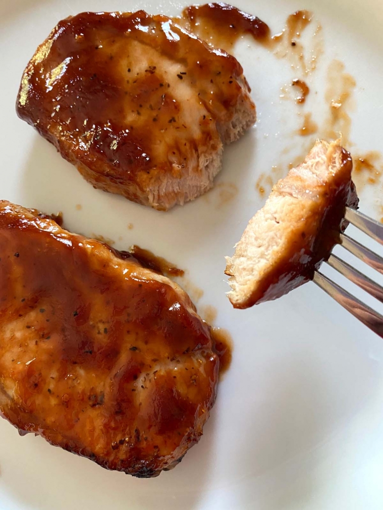 fork holding piece of bbq pork chops