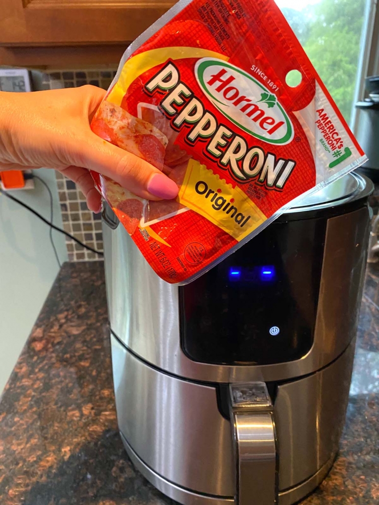 package of pepperoni slices in front of air fryer