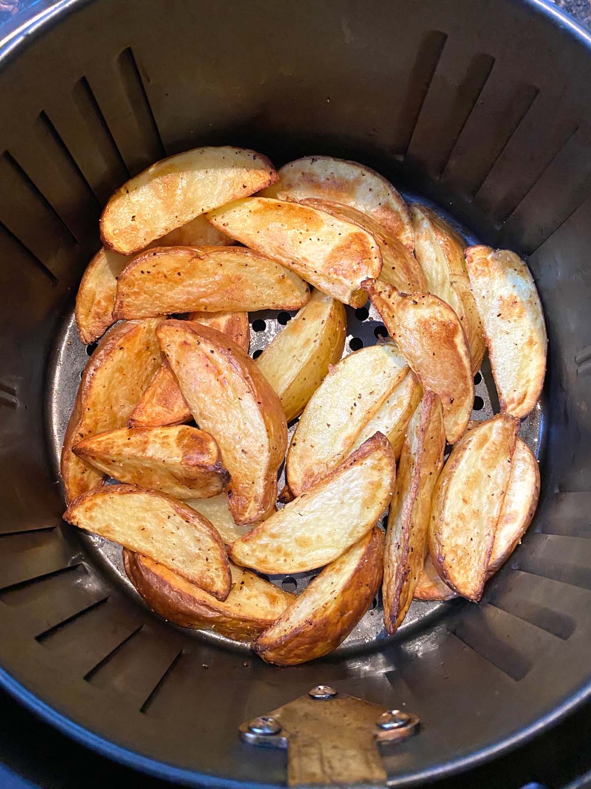 Cooked potato wedges in the air fryer.
