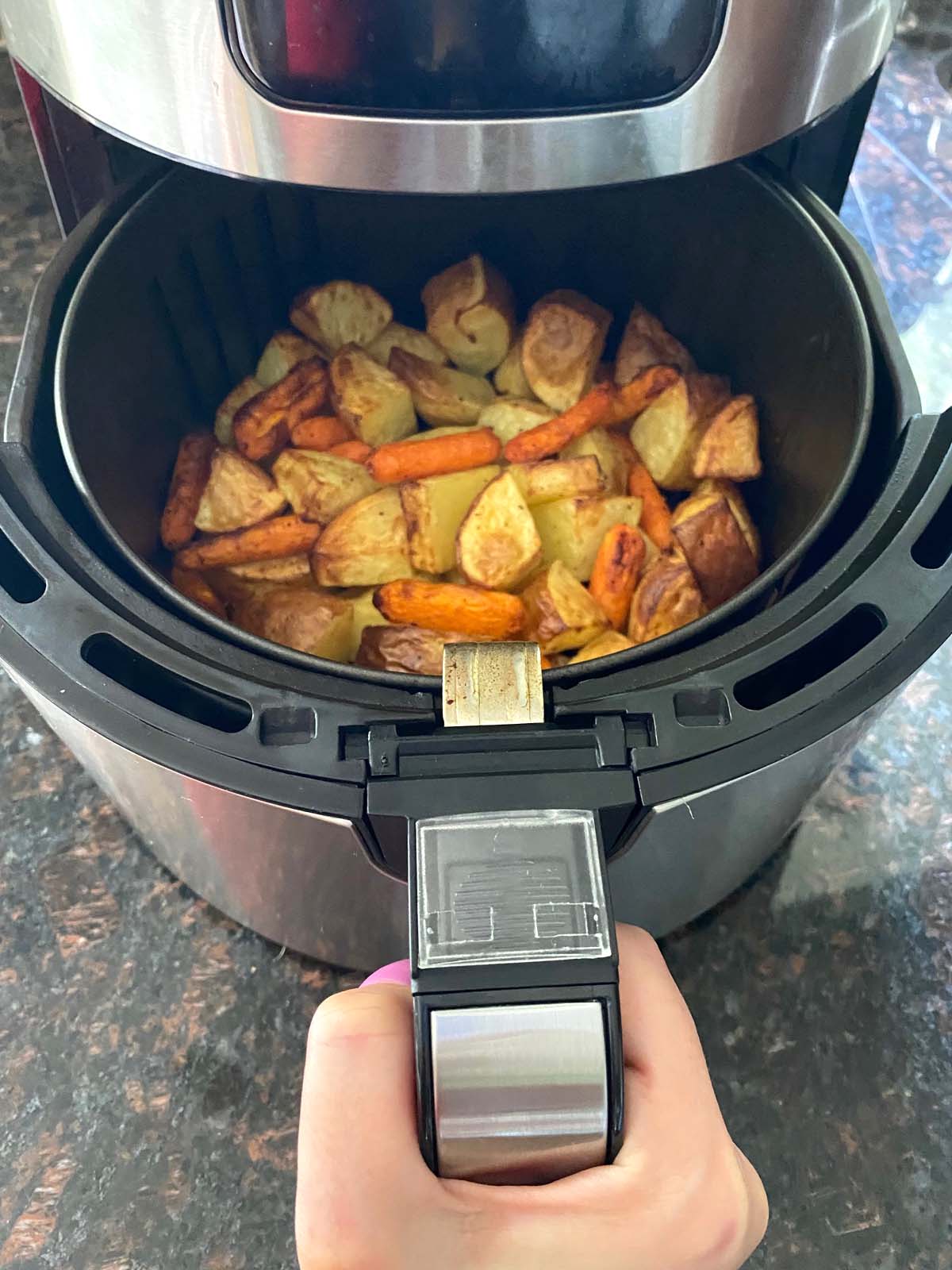 Roasted potatoes and carrots in an air fryer.