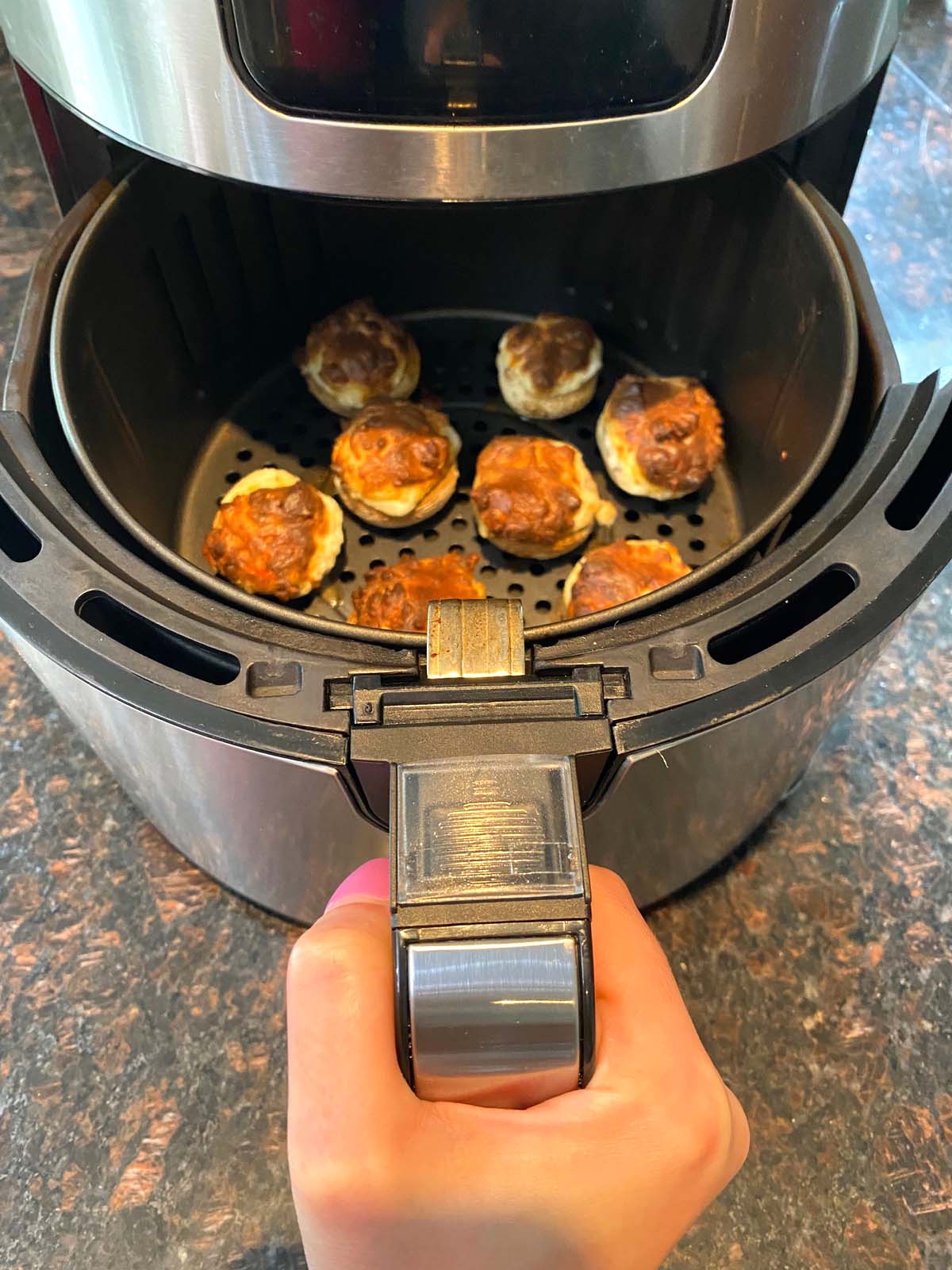Cooked stuffed mushrooms in an air fryer. 
