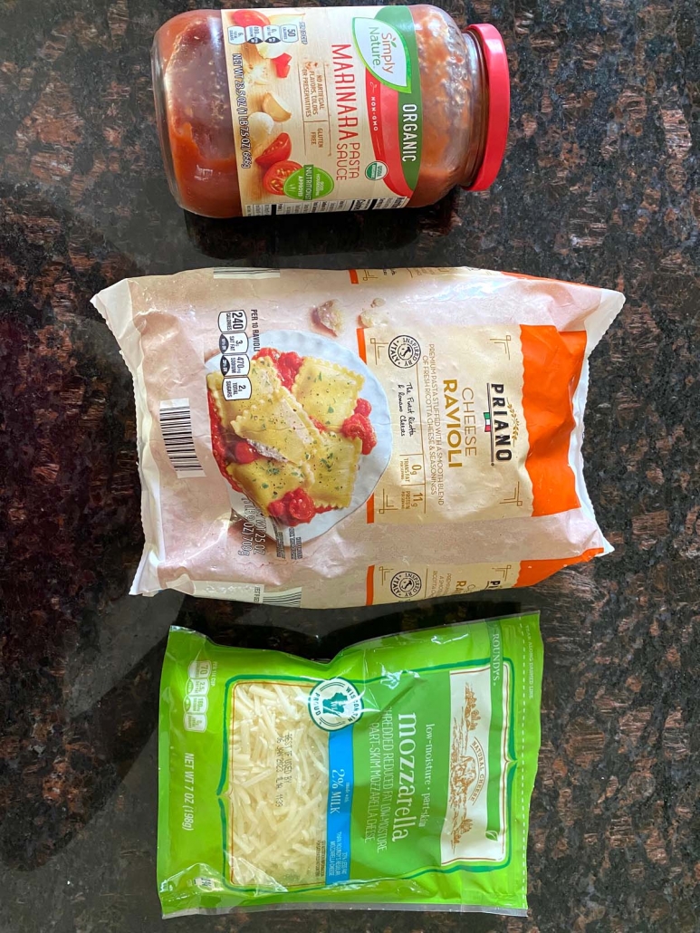 package of frozen ravioli next to jar of pasta sauce and package of shredded mozzarella cheese