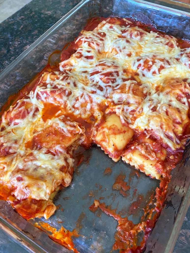 baked ravioli in a dish with a piece cut out