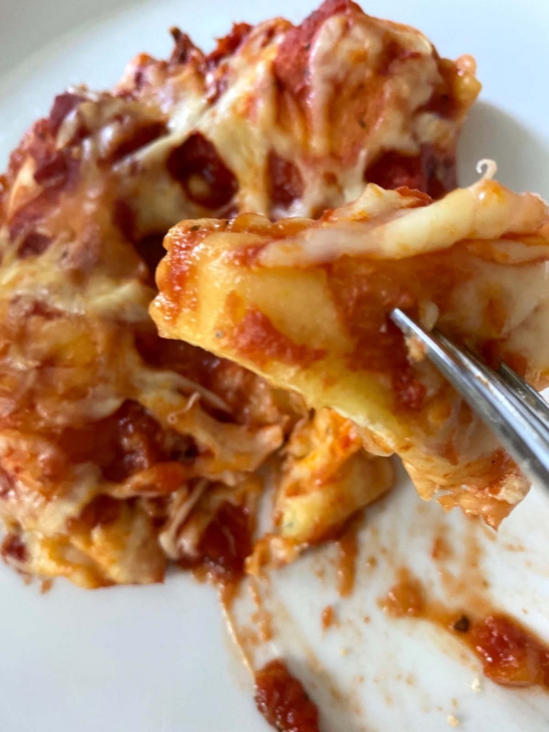 fork holding piece of cheese ravioli