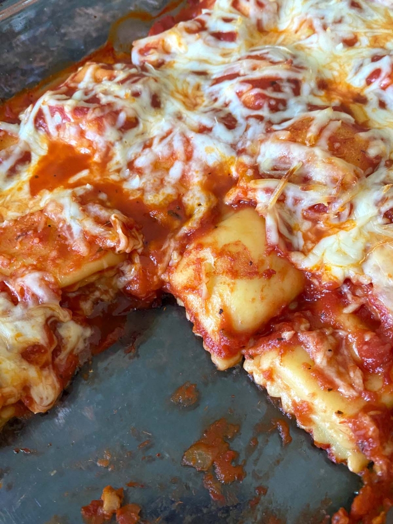 close-up of layers of baked ravioli, sauce, and melted cheese
