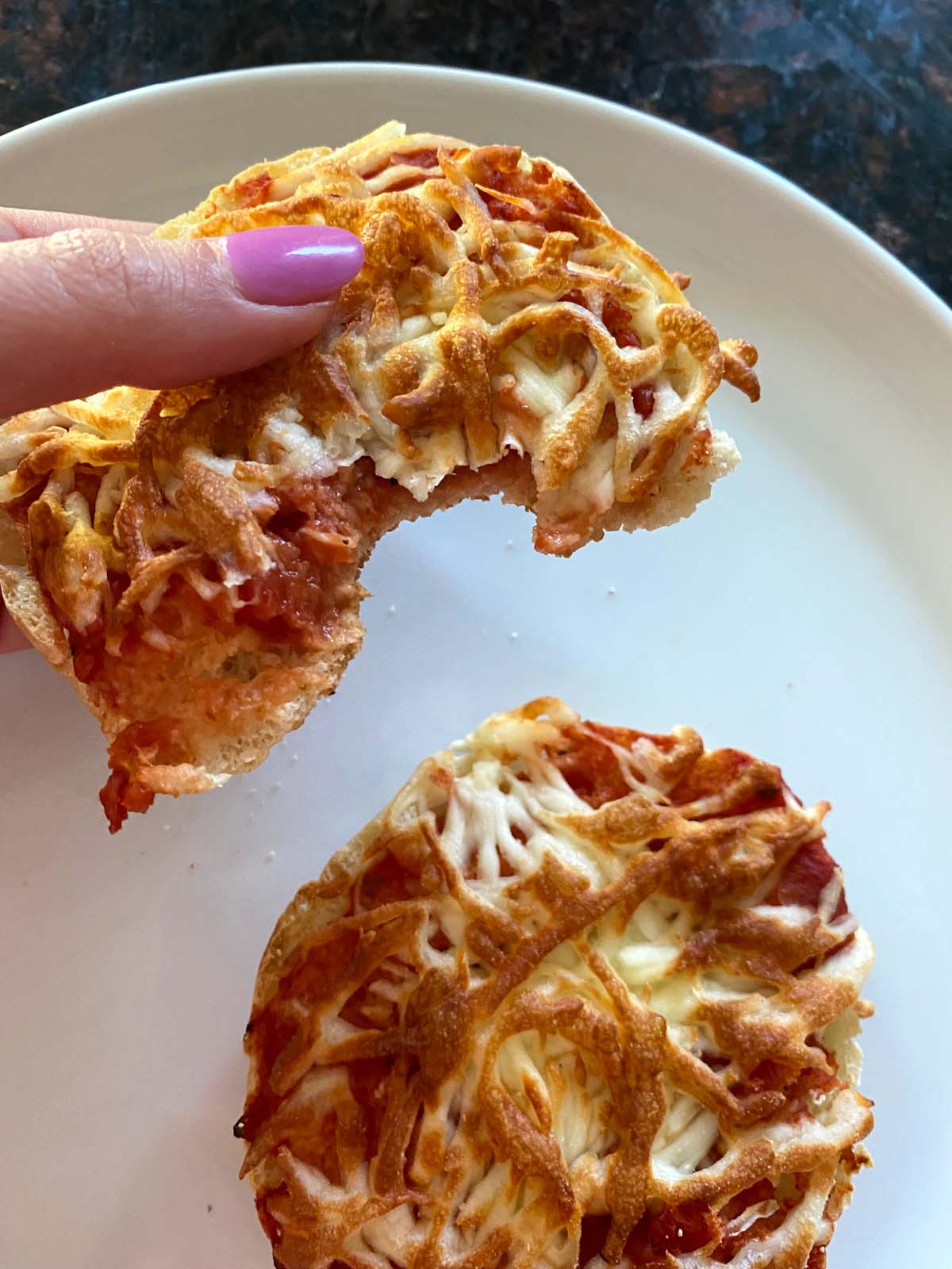 Air fryer english muffin pizza on a plate. 