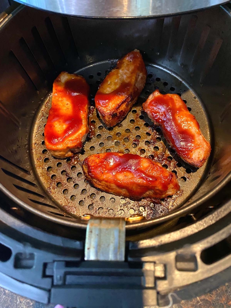 cooked and seasoned pork ribs inside air fryer