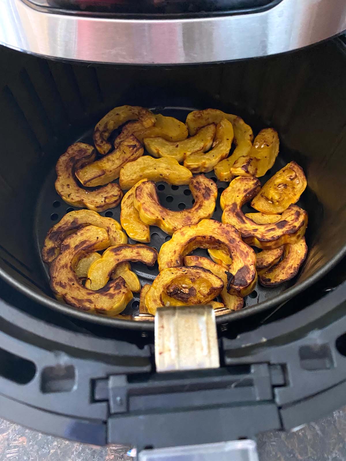 Cooked delicata squash in an air fryer.