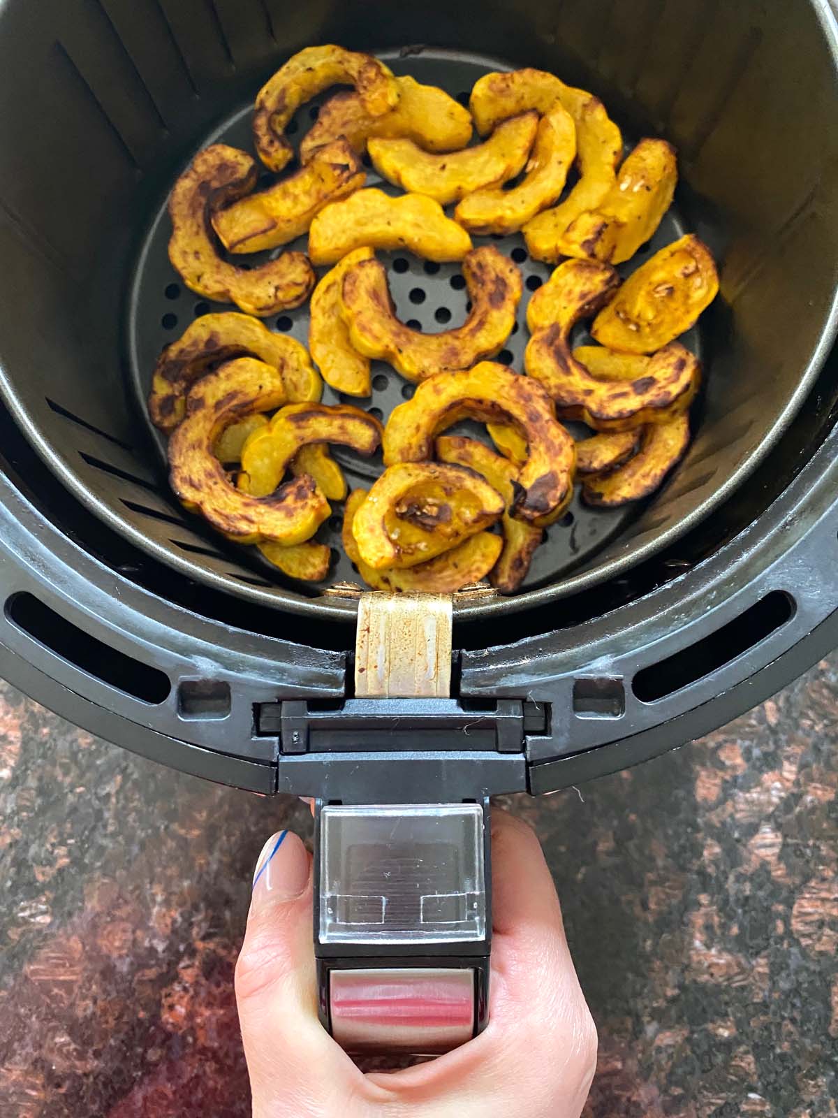 Cooked delicata squash in an air fryer.